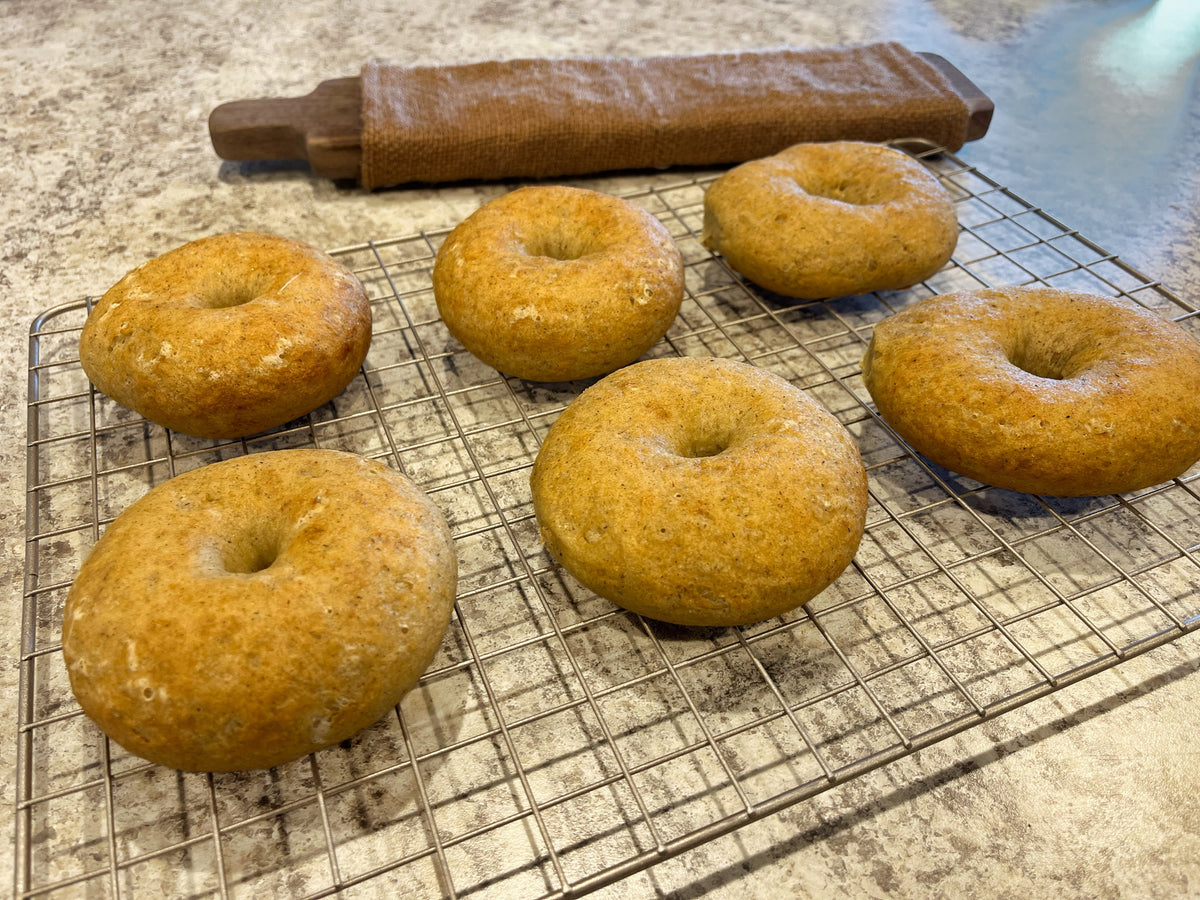 Puffy gluten free bagels on cooling rack.