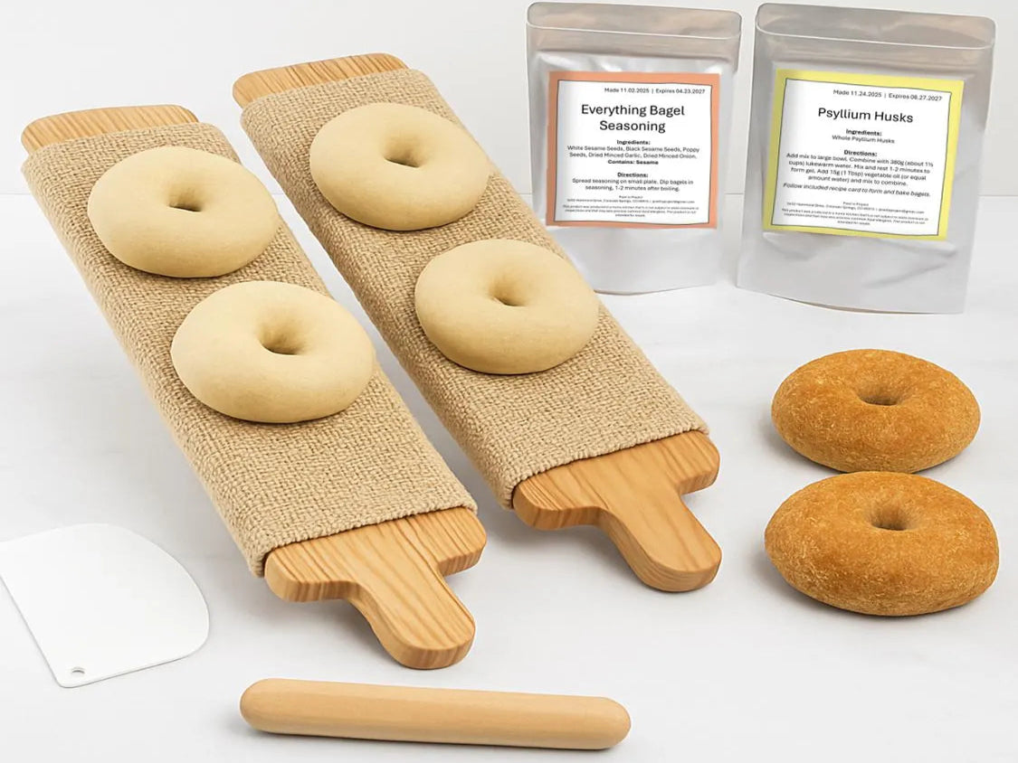 Two bagel boards on white countertop surrounded by tools and gluten free ingredients.