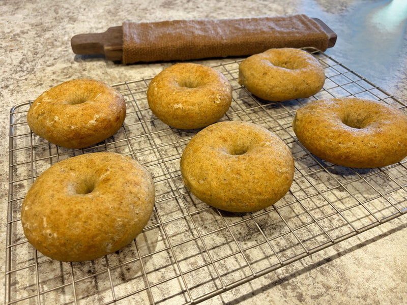 Puffy gluten free bagels on cooling rack.