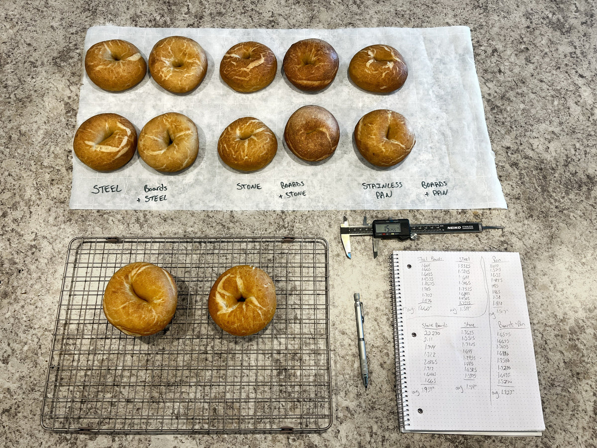 Bagels on parchment paper labeled with different baking surfaces used with measuring equipment.